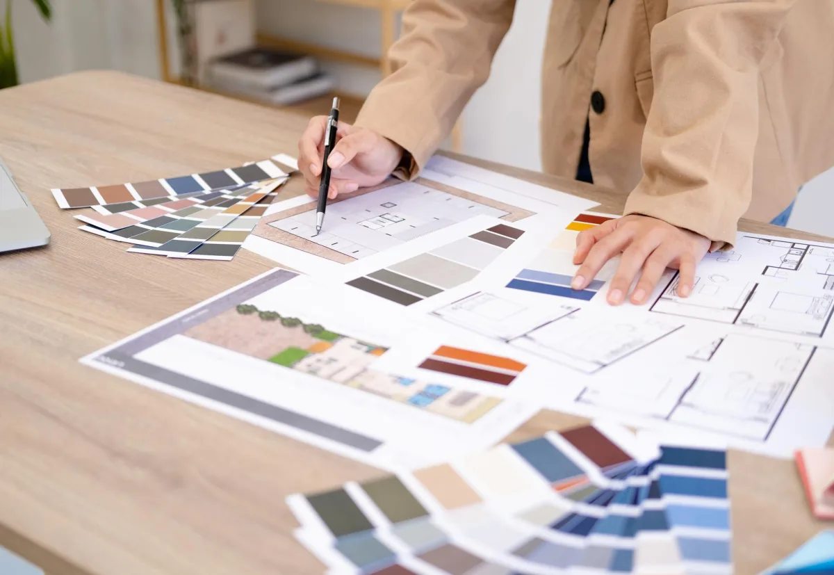 Designer reviewing floor plans and material samples